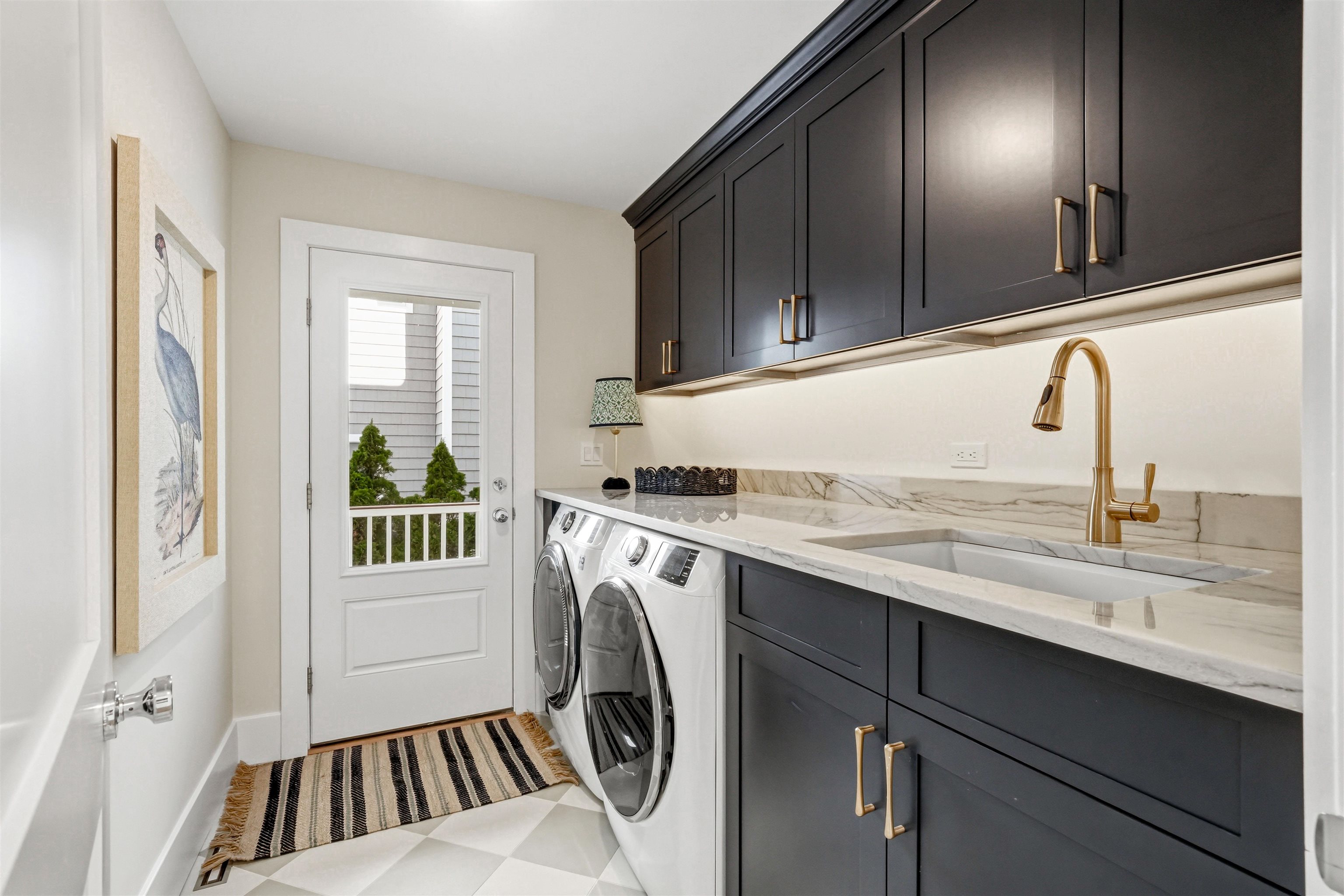 46 West 31st Avalon, NJ 08202 - Photo 11 of 50 a kitchen with a sink a washer and dryer