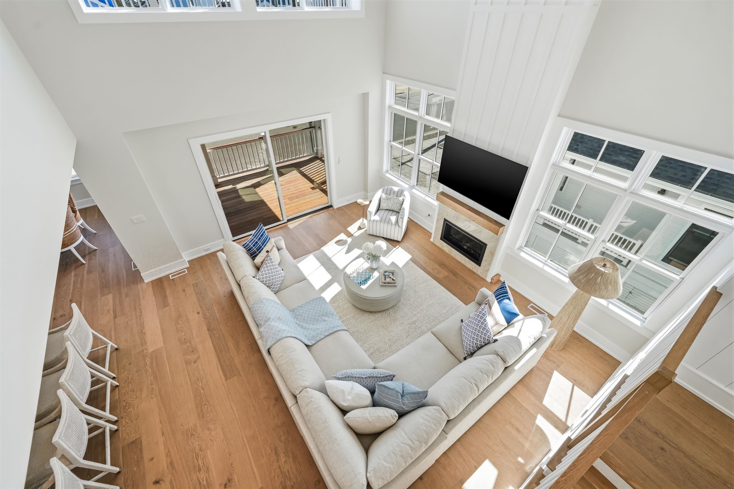 46 West 31st Avalon, NJ 08202 - Photo 23 of 50 a living room with furniture a flat screen tv and a floor to ceiling window