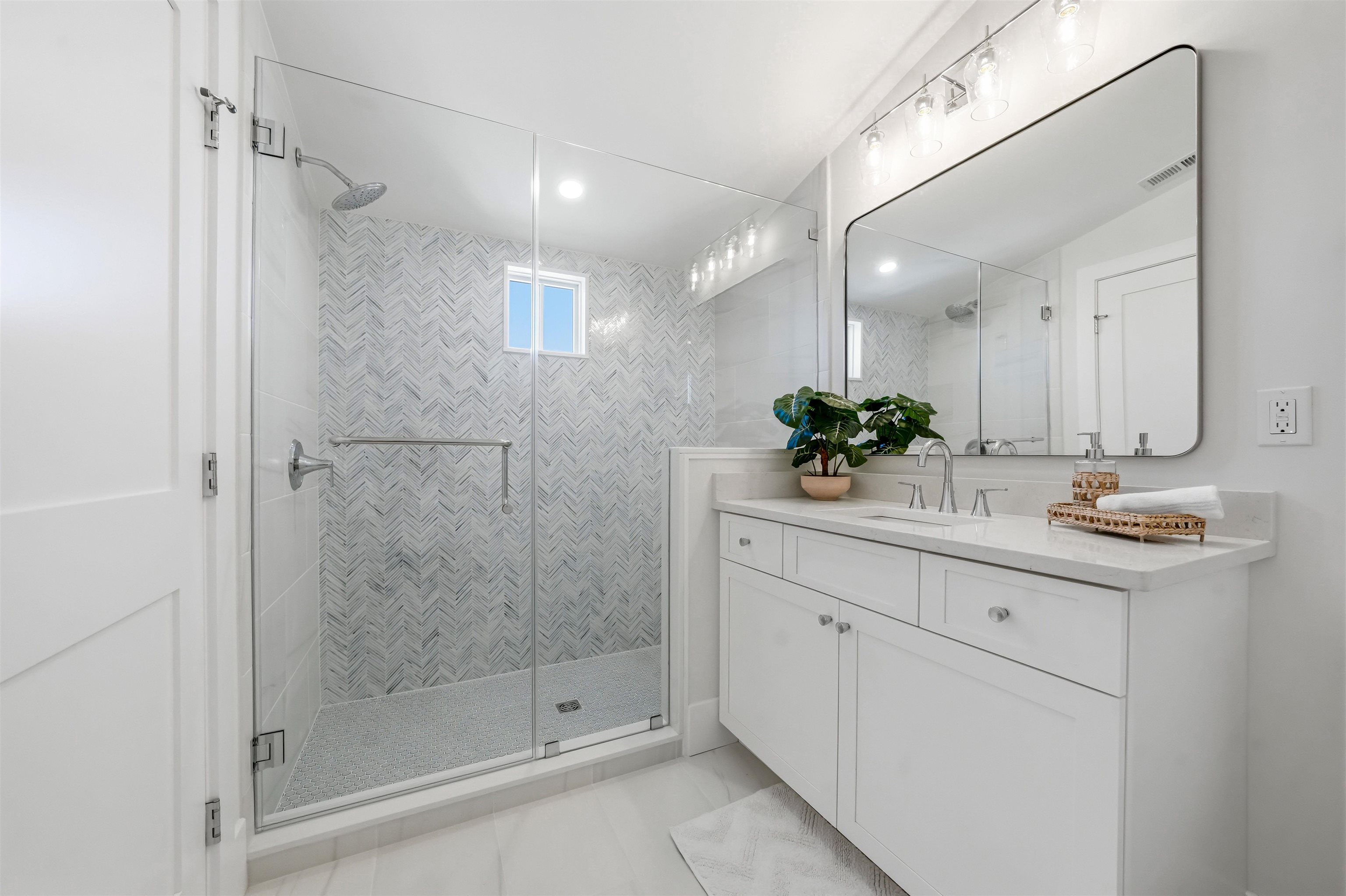 46 West 31st Avalon, NJ 08202 - Photo 39 of 50 a bathroom with a shower sink and mirror