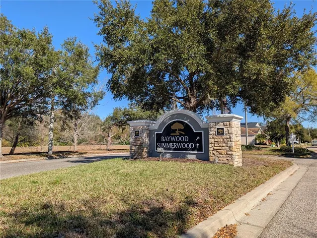 a front view of a house with a yard covered with snow