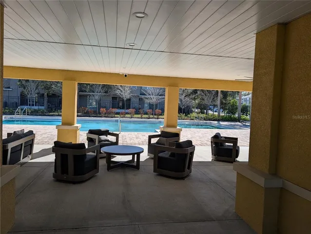 a living room with furniture and a floor to ceiling window