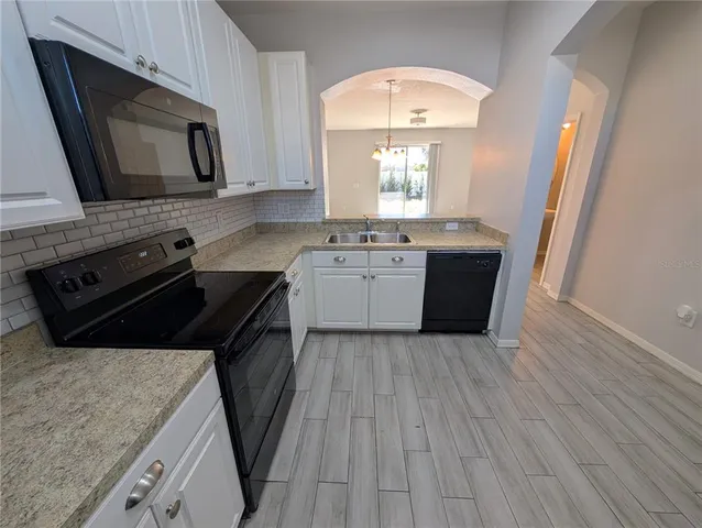 a kitchen with a stove microwave and sink