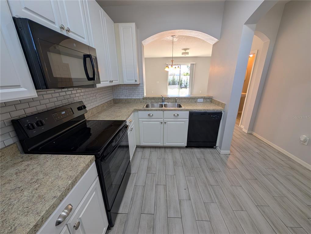 8955 Walnut Gable Court Riverview, FL 33578 - Photo 4 of 15 a kitchen with a stove microwave and sink