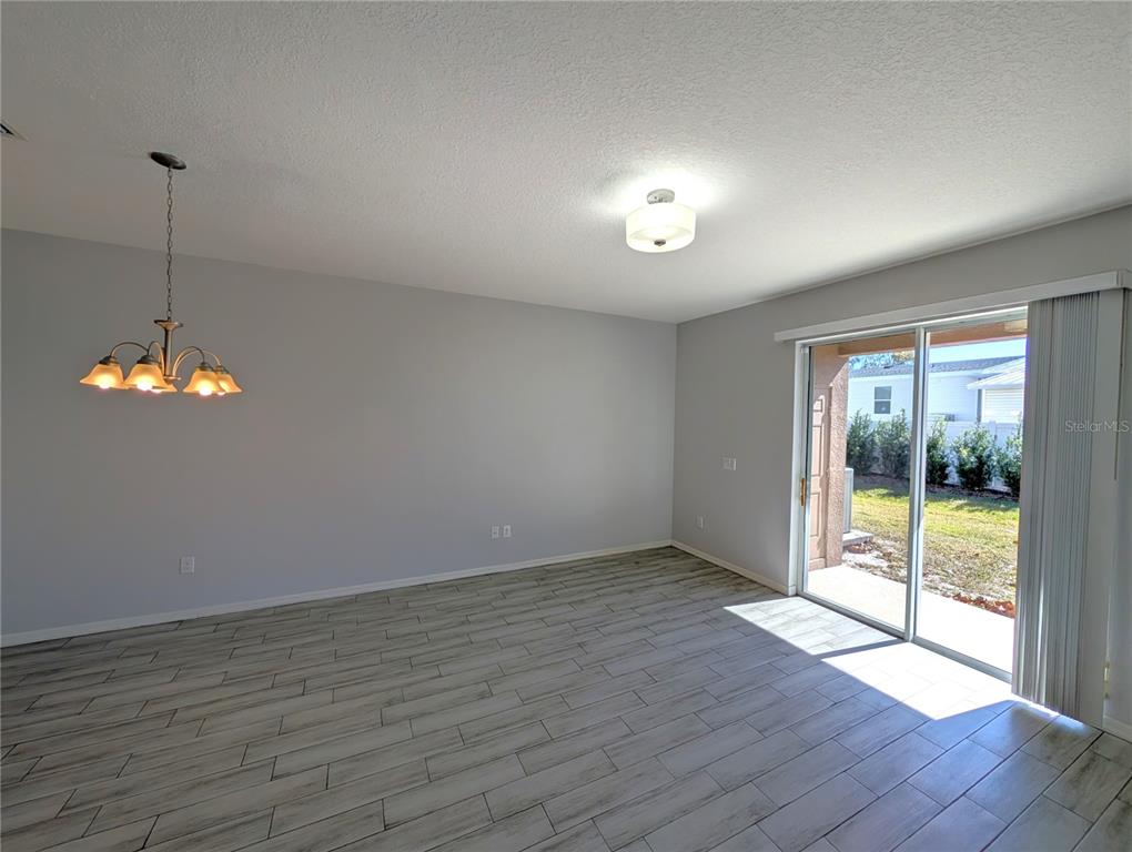 8955 Walnut Gable Court Riverview, FL 33578 - Photo 6 of 15 an empty room with wooden floor and windows
