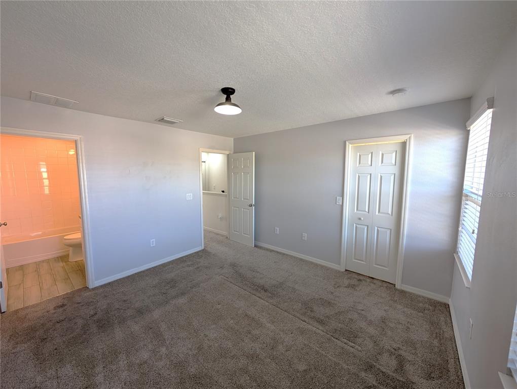 8955 Walnut Gable Court Riverview, FL 33578 - Photo 9 of 15 an empty room with windows and closet