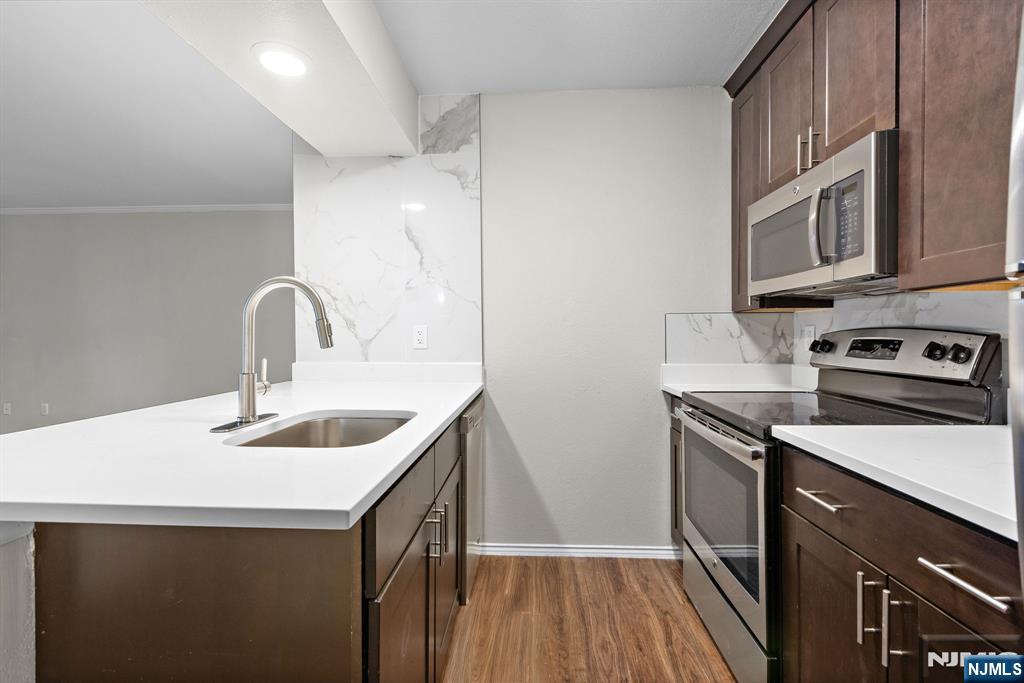 690 Route 23 Wayne, NJ 07470 - Photo 4 of 11 a kitchen with sink a microwave and stove