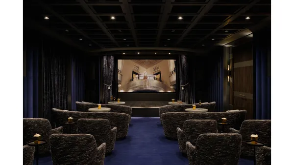 a living room with furniture and a lamp