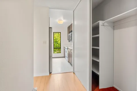 a view of hallway with wooden floor and stairs