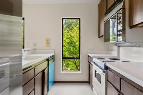 a kitchen that has a sink and a stove