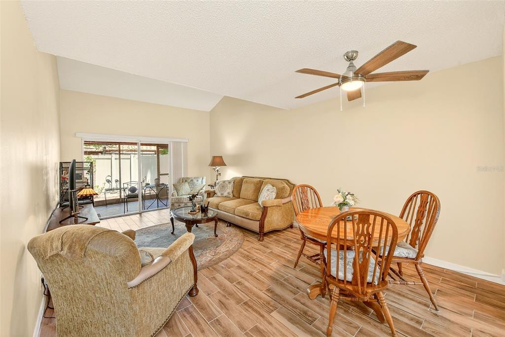2064 Sunset Point Road, Unit 73 Clearwater, FL 33765 - Photo 12 of 58 a living room with furniture and a wooden floor