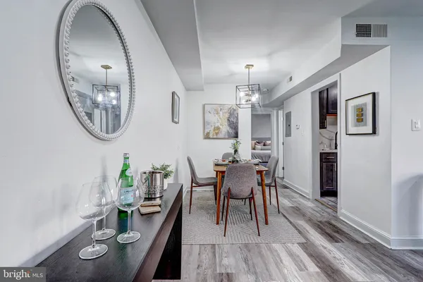 a dining room with furniture and wooden floor