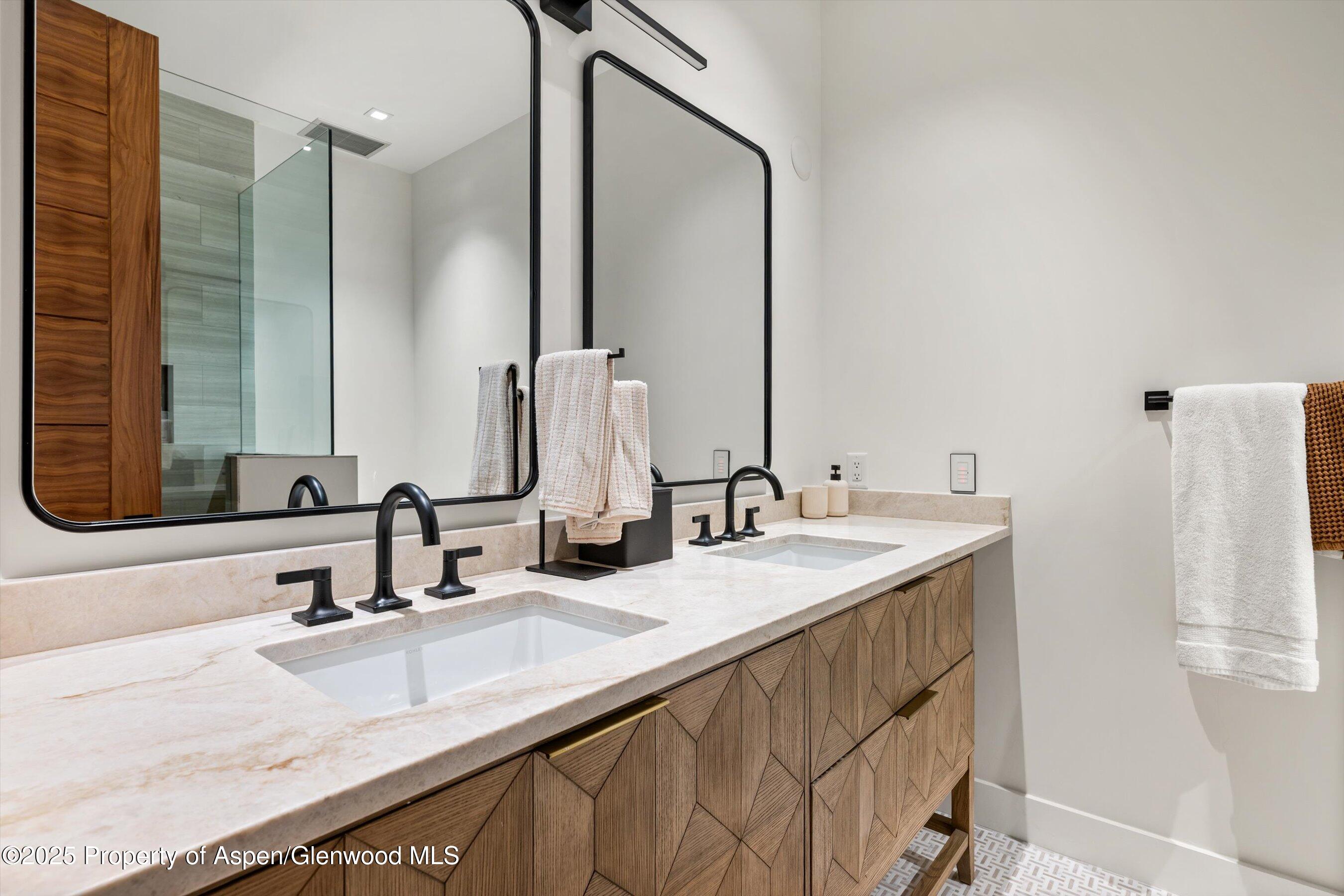 1234 Wood Road Snowmass Village, CO 81615 - Photo 54 of 66 a bathroom with double vanity sink and a mirror