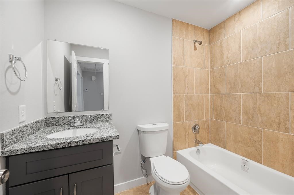 7804 Crestview Drive, Unit B Houston, TX 77028 - Photo 12 of 23 a bathroom with a granite countertop sink a toilet and shower