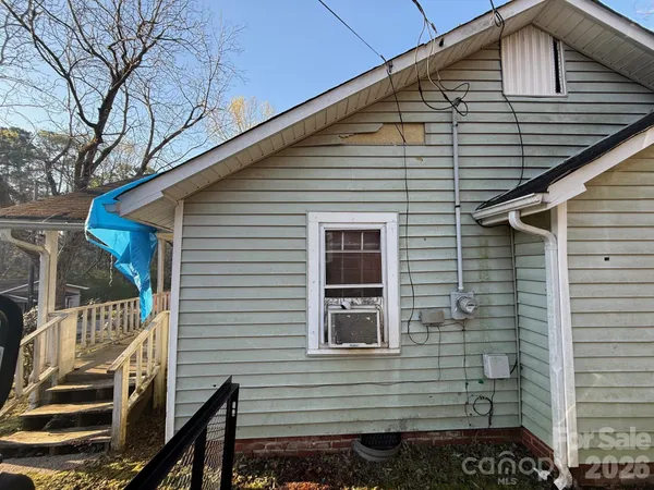 a view of a house with a small car
