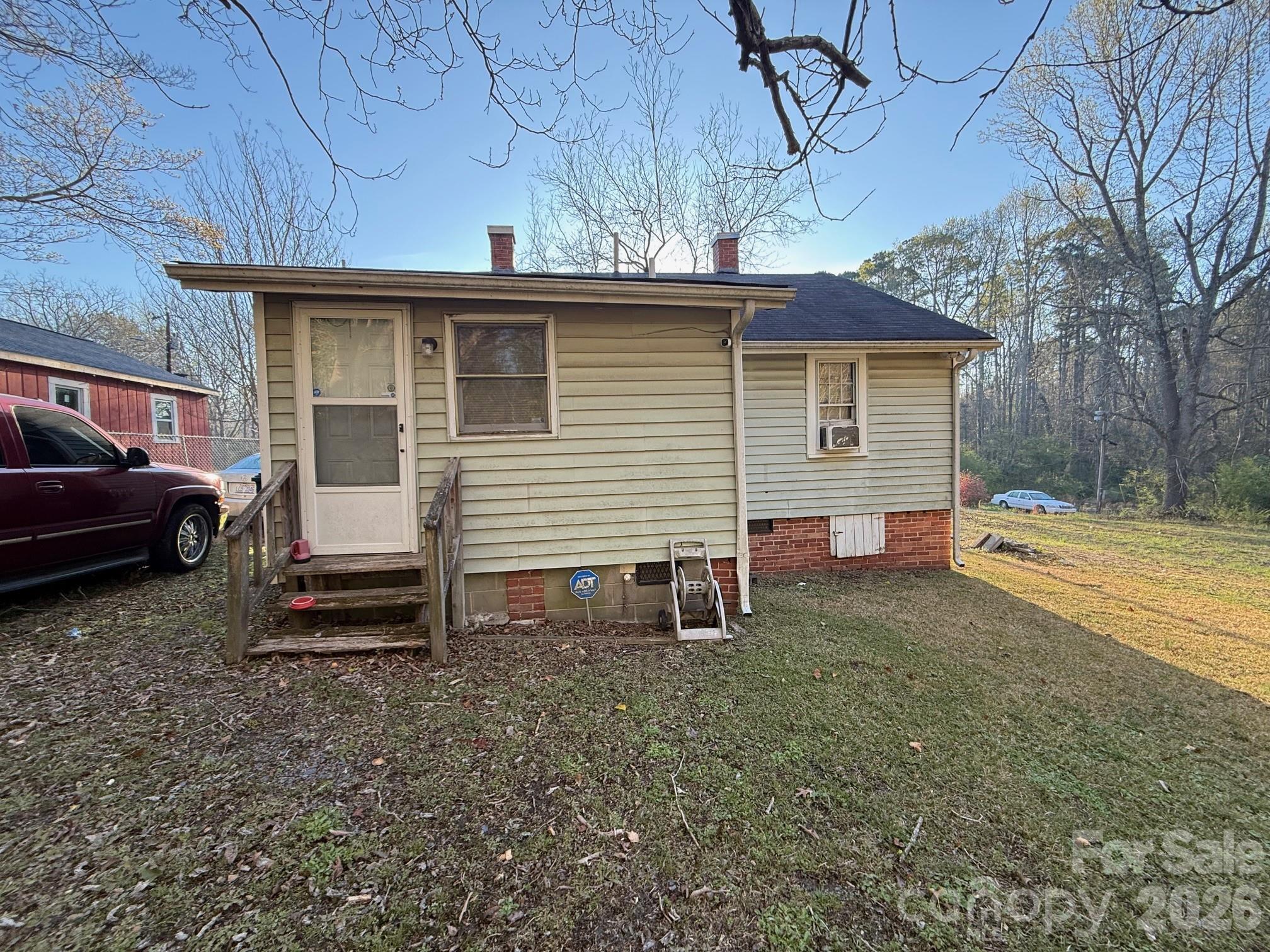 624 Blue Street Troy, NC 27371 - Photo 8 of 14 a view of a house with a backyard and a tree