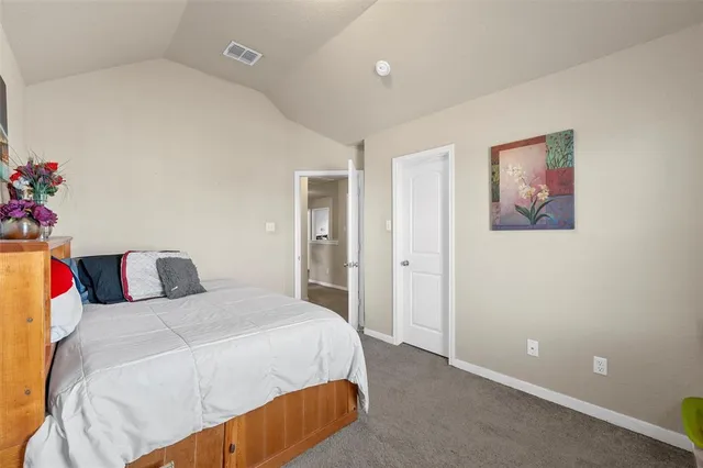 a bedroom with a bed and a potted plant