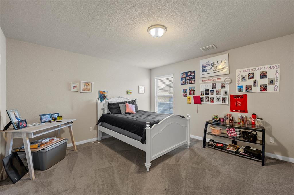 10620 Langham Drive Waco, TX 76708 - Photo 18 of 30 a bedroom with furniture and a bed