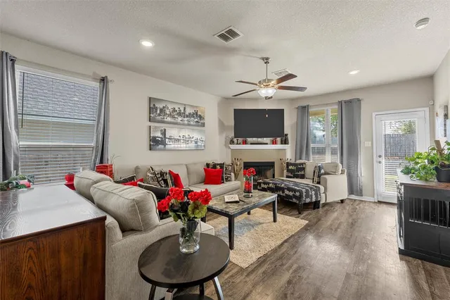 a living room with furniture kitchen view and a flat screen tv