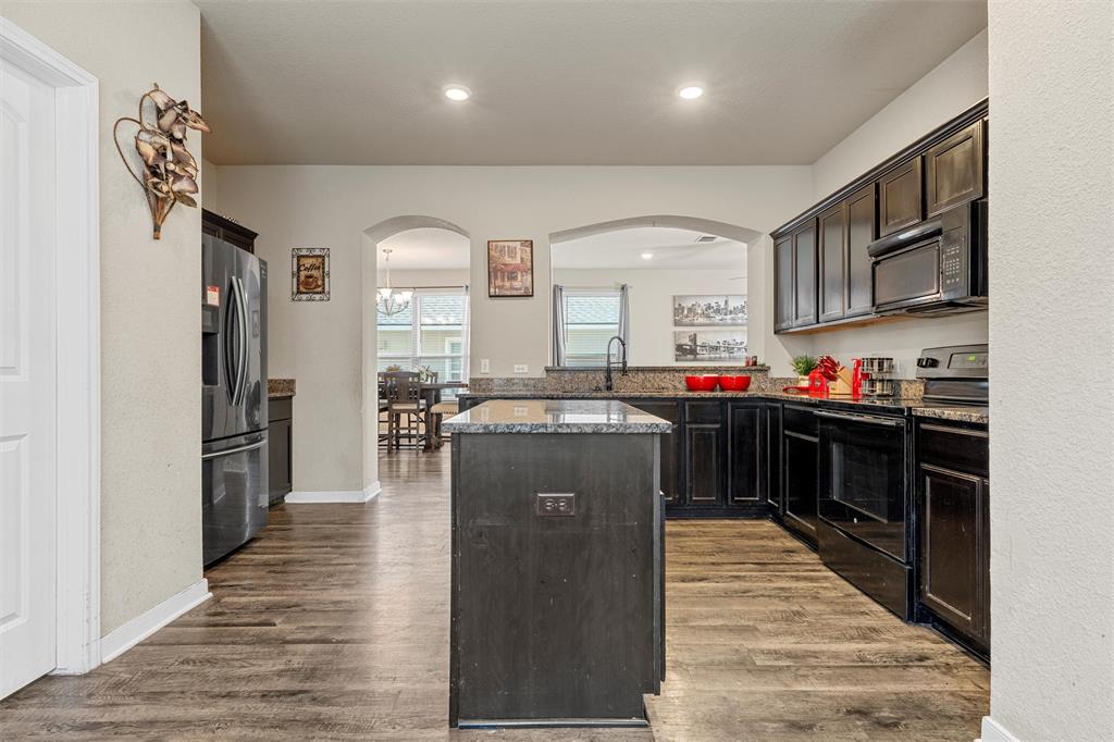 10620 Langham Drive Waco, TX 76708 - Photo 8 of 30 a kitchen with stainless steel appliances granite countertop a refrigerator a stove and a sink