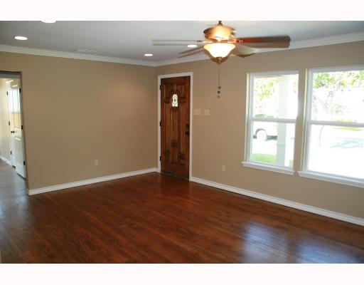 633 Chamberlain Street Corpus Christi, TX 78404 - Photo 2 of 9 a view of an empty room with window and wooden floor