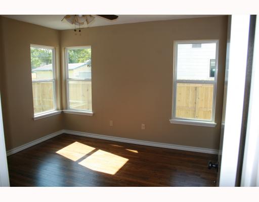 633 Chamberlain Street Corpus Christi, TX 78404 - Photo 8 of 9 a view of an empty room with wooden floor and a window