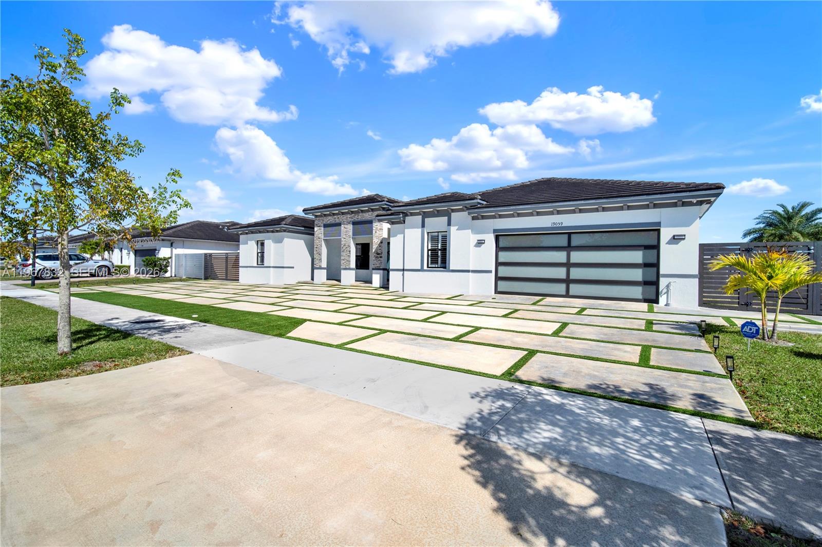 a view of a house with swimming pool and a yard