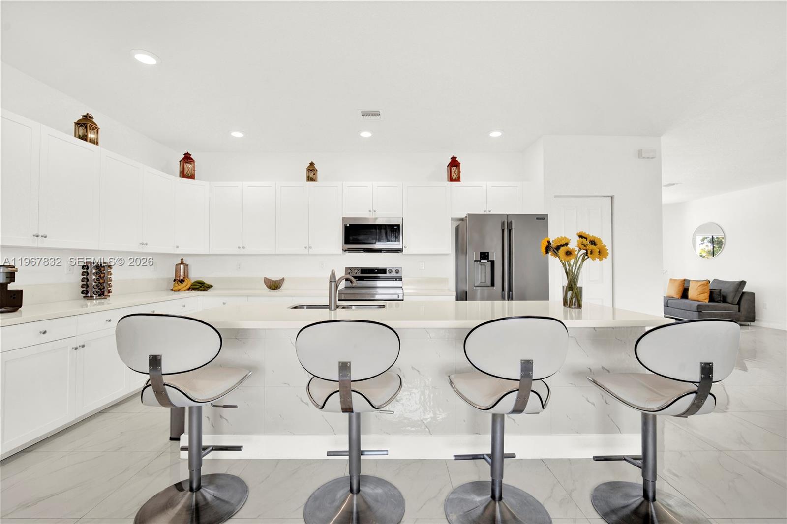 19059 Southwest 134th Court Miami, FL 33177 - Photo 12 of 52 a kitchen with stainless steel appliances granite countertop a sink and white cabinets with wooden floor