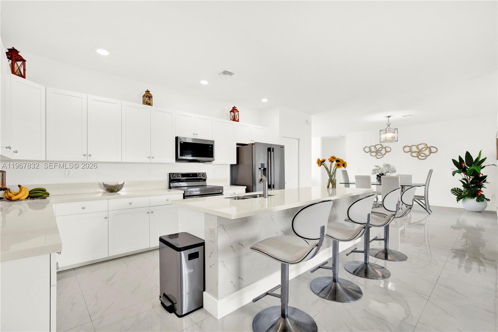 19059 Southwest 134th Court Miami, FL 33177 - Photo 13 of 52 a kitchen with furniture a center island and stainless steel appliances