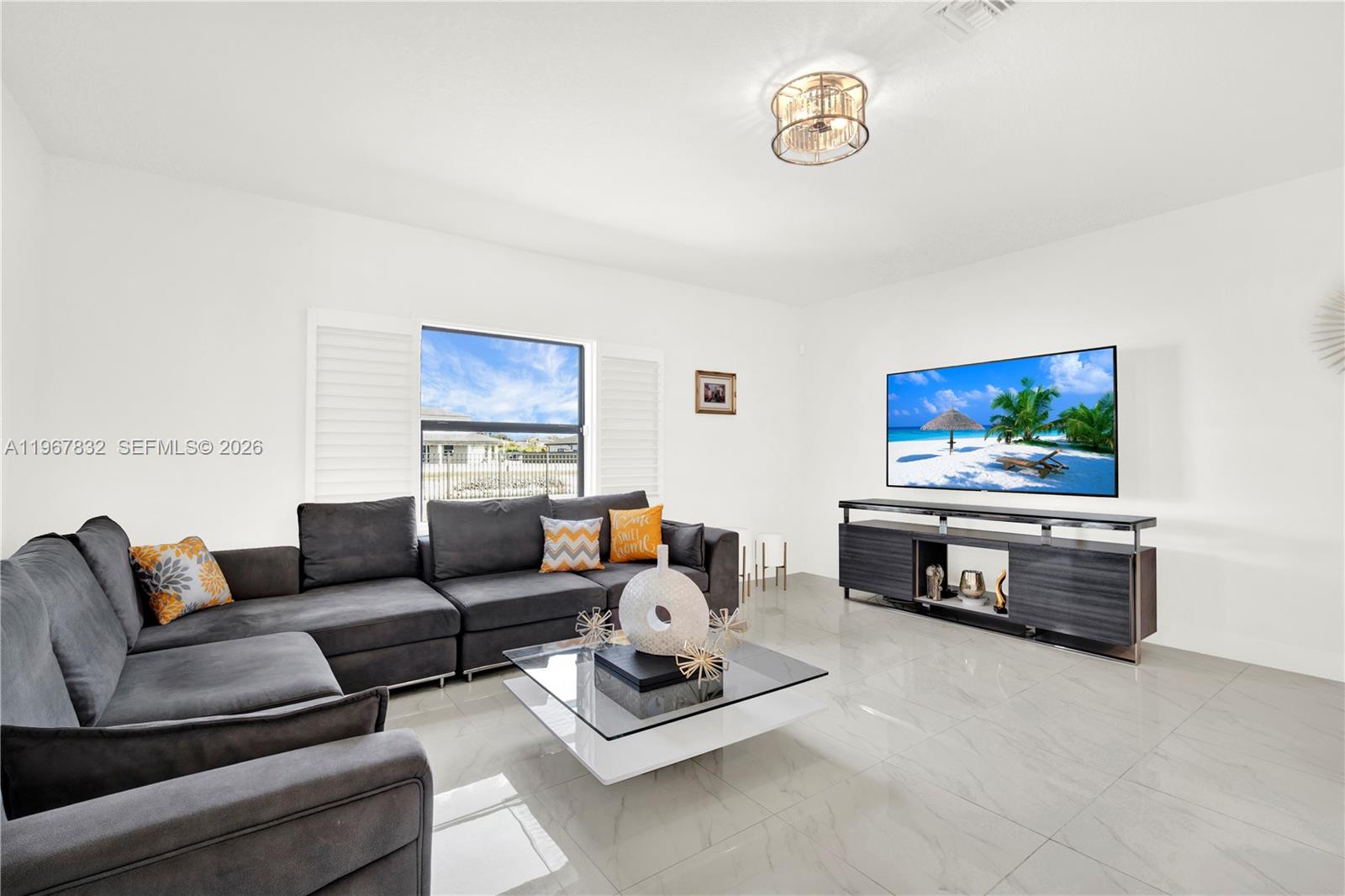 19059 Southwest 134th Court Miami, FL 33177 - Photo 15 of 52 a living room with furniture and a flat screen tv