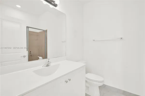 a bathroom with a sink a toilet and mirror