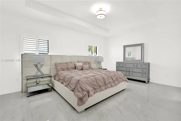 a bedroom with a bed and a night stand