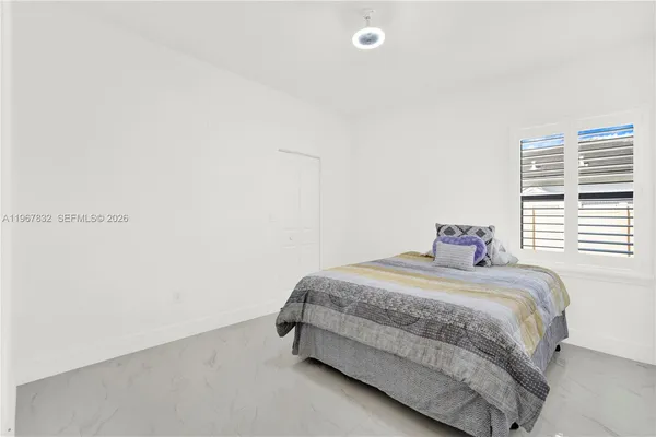 a bedroom with a bed and a window