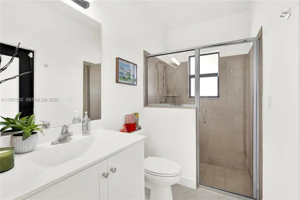 a bathroom with a sink toilet and shower