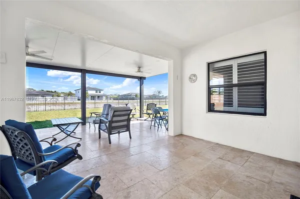 a living room with furniture and large windows