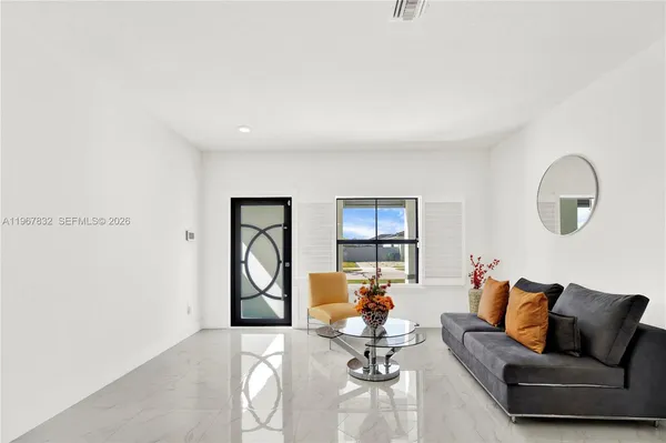 a living room with furniture a rug and wall painting