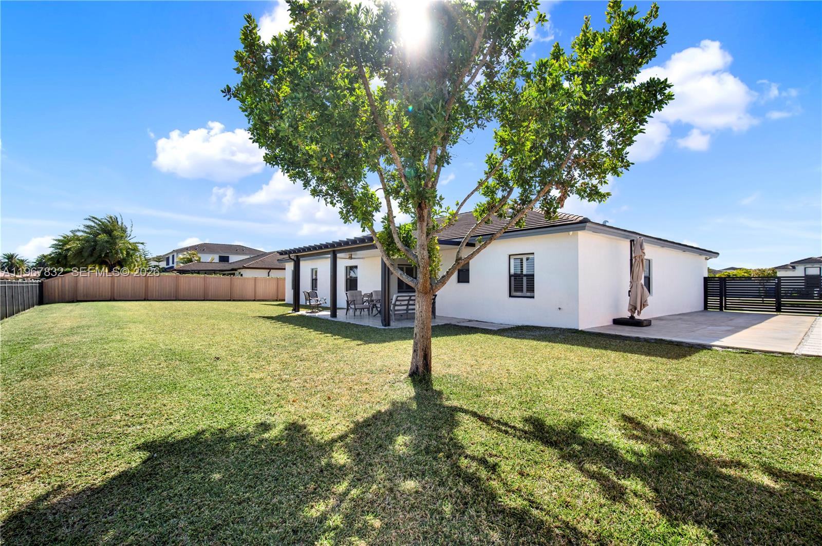 19059 Southwest 134th Court Miami, FL 33177 - Photo 42 of 52 a front view of a house with a yard garage and outdoor seating