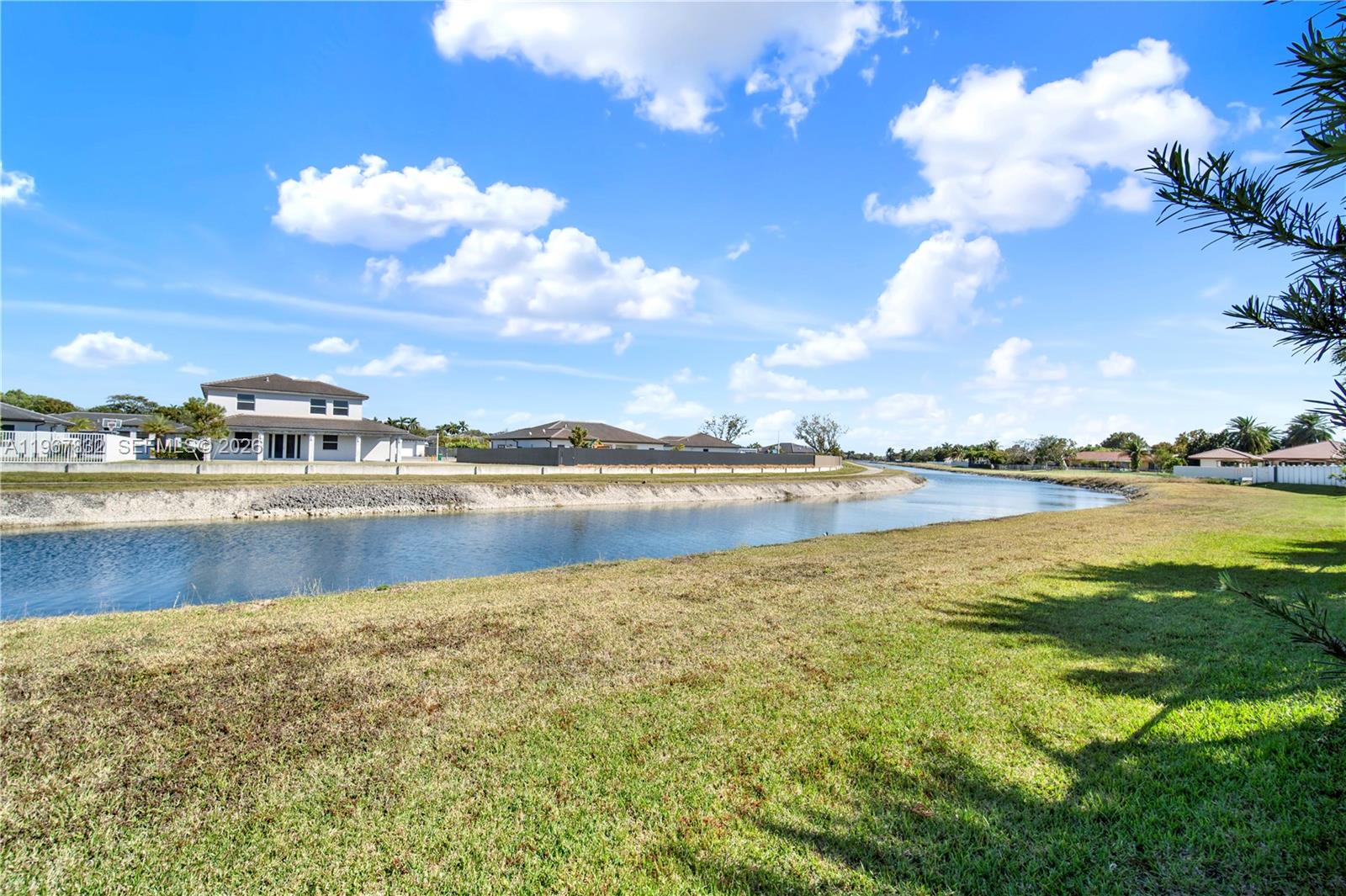 19059 Southwest 134th Court Miami, FL 33177 - Photo 44 of 52 a view of a lake with houses in the back