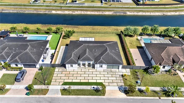 an aerial view of a residential houses with outdoor space