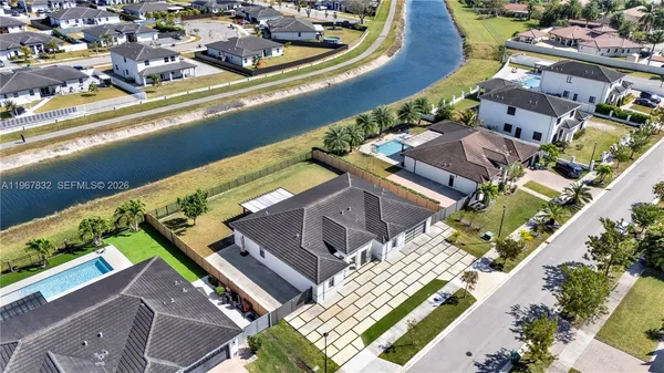 an aerial view of residential houses with outdoor space and swimming pool