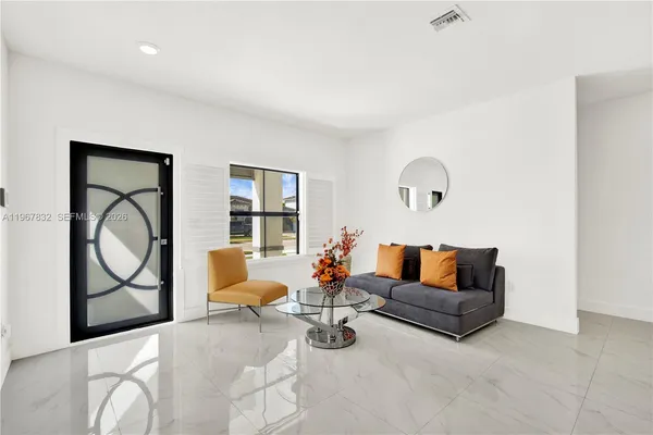 a living room with furniture and a potted plant