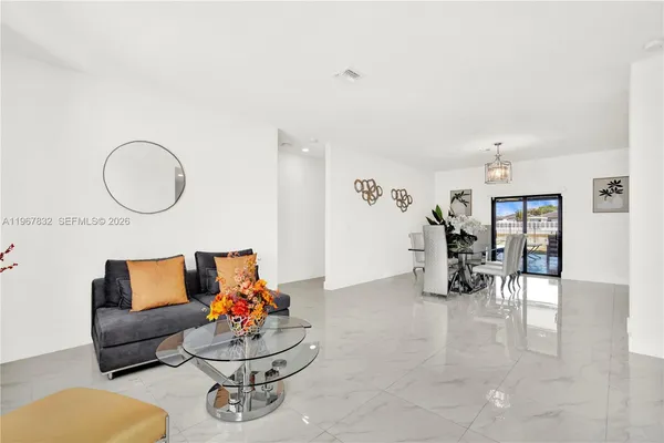 a living room with furniture and white walls