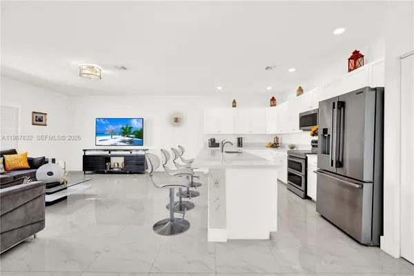 a kitchen with sink refrigerator and microwave