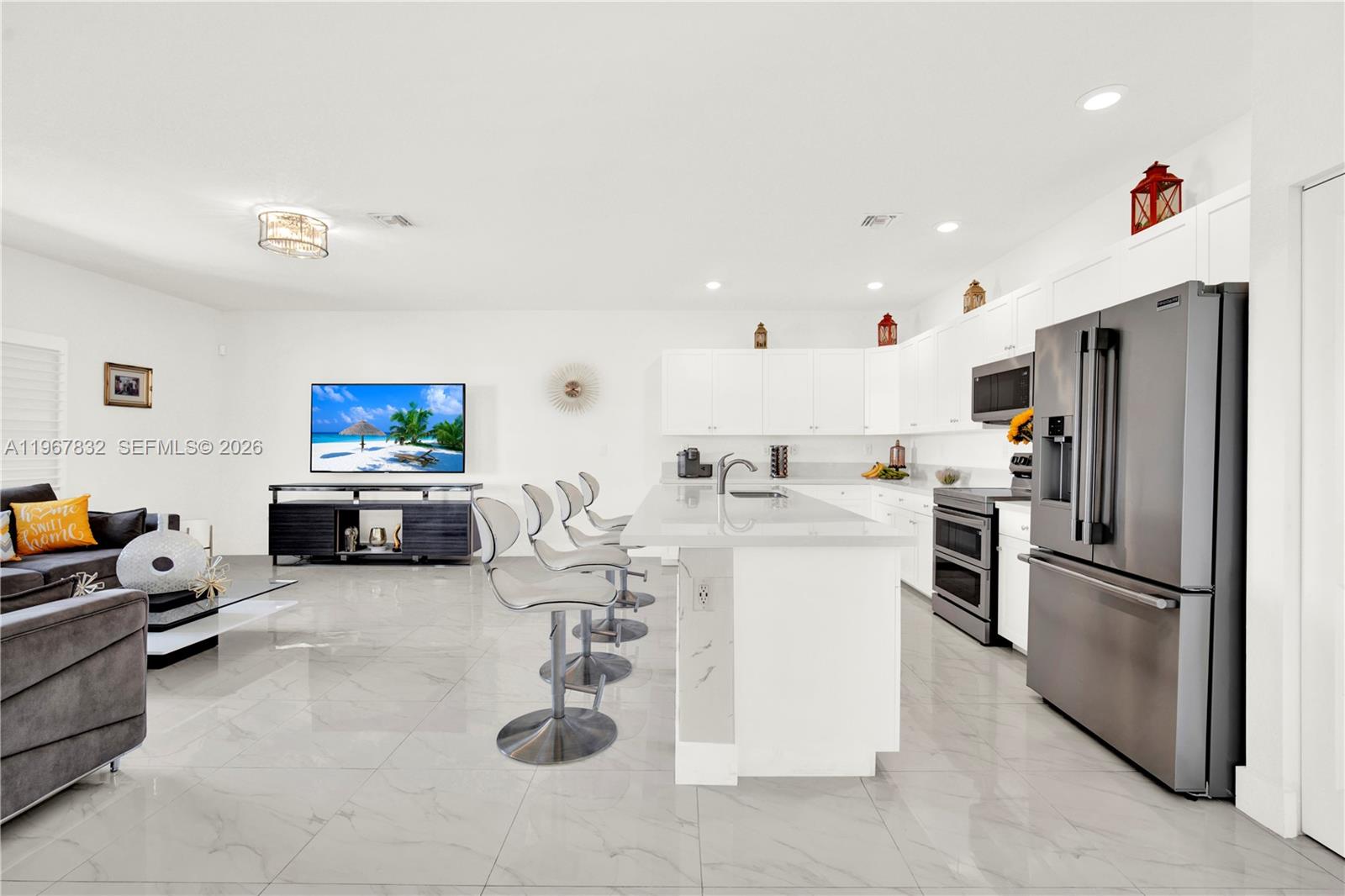 19059 Southwest 134th Court Miami, FL 33177 - Photo 10 of 52 a kitchen with sink refrigerator and microwave