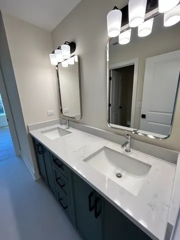 a bathroom with a double vanity sink and a mirror