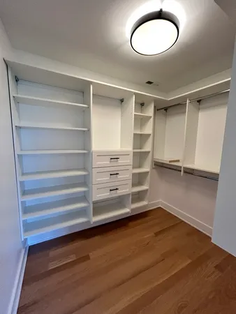 a view of walk in closet with empty racks