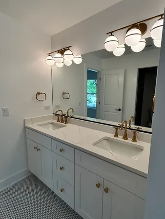 a bathroom with a double vanity sink and a mirror