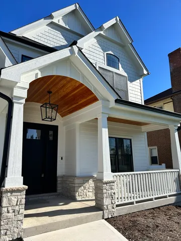 a view of a white house with large windows