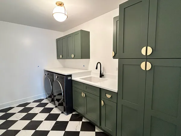 a kitchen with a sink a refrigerator and cabinets