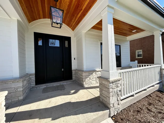 a view of a porch with wooden floor and fence