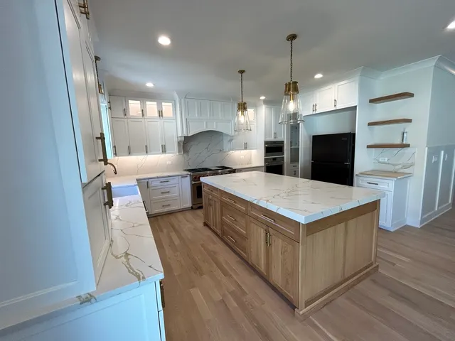 a kitchen with a stove a refrigerator and a microwave